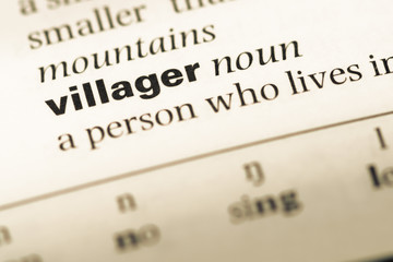Close up of old English dictionary page with word villager