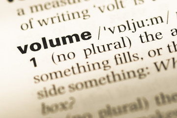 Close up of old English dictionary page with word volume