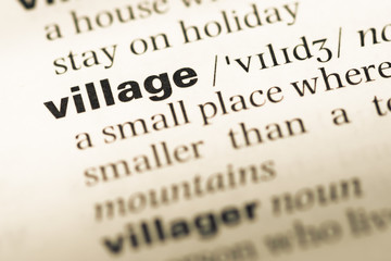 Obraz premium Close up of old English dictionary page with word village