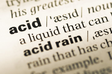 Obraz premium Close up of old English dictionary page with word acid