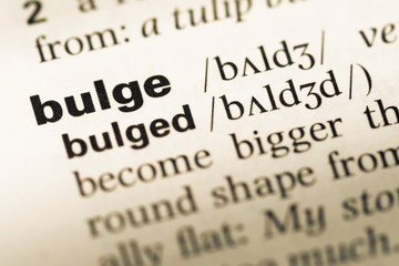 Obraz premium Close up of old English dictionary page with word bulge