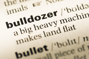Obraz premium Close up of old English dictionary page with word bulldozer