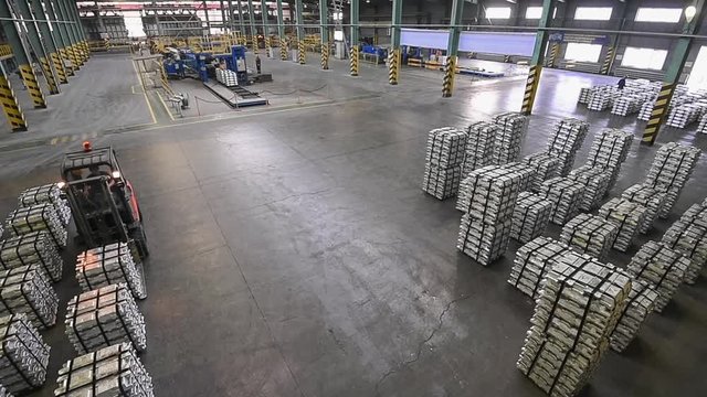 Forklift trucks load pallets. Aluminum pigs.
