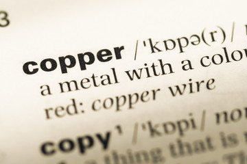 Close up of old English dictionary page with word copper