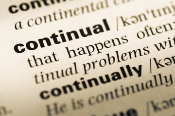 Close up of old English dictionary page with word continual