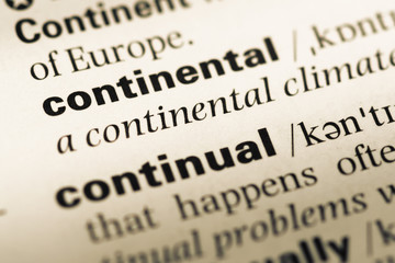 Obraz premium Close up of old English dictionary page with word continental