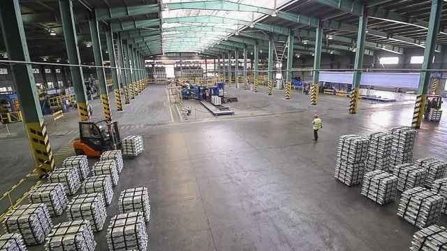Forklift trucks load pallets. Aluminum pigs.