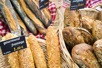 French breads with sign on red checked cloth in Paris market