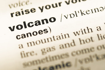 Obraz premium Close up of old English dictionary page with word volcano