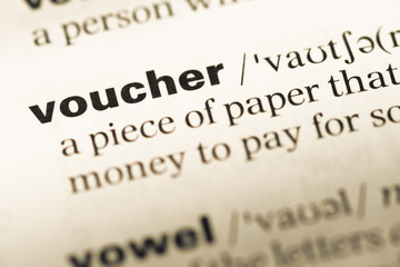 Close up of old English dictionary page with word voucher