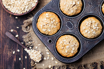 Healthy vegan oat muffins, apple and banana cakes in vintage pan Top view