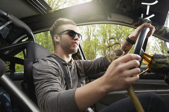 Portrait of man driving wearing sunglasses