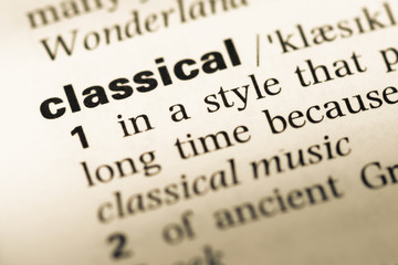 Obraz premium Close up of old English dictionary page with word classical