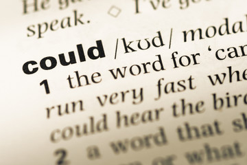 Close up of old English dictionary page with word could