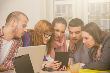Young group of people/architects discussing business plans.