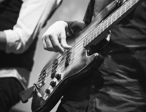 Bass guitar player, closeup photo