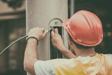 Engineer working on a light pole.