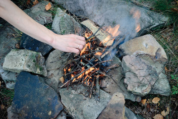 kindling a fire in the mountains on the rocks