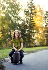 Obraz na płótnie Canvas traveler girl with a suitcase