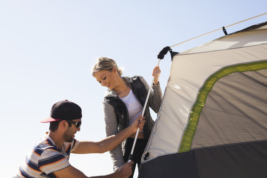 Couple setting up tent