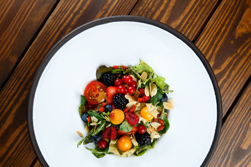 Summer salad with nut mass and seasonal berries selected focus
