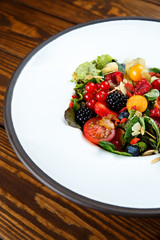 Summer salad with nut mass and seasonal berries selected focus