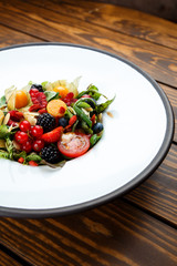 Summer salad with nut mass and seasonal berries selected focus