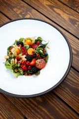 Summer salad with nut mass and seasonal berries selected focus