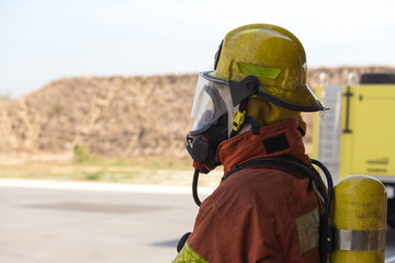 single fireman in fire fighting protection suit
