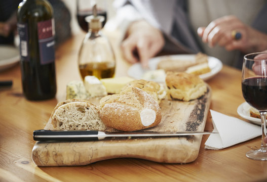 Freshly baked bread on breadboard, close up