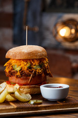 Pulled pork BBQ burger with tomatoes and jalapeno selected focus