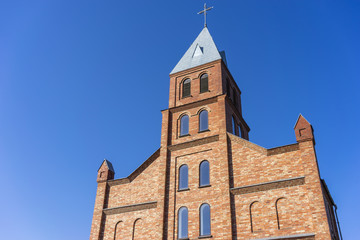 Fototapeta na wymiar Catholic church in Europe against blue sky