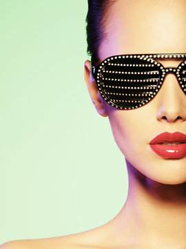 Fashion portrait of  woman wearing black sunglasses with strass