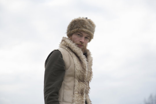 Mid adult man wearing furry waistcoat and trapper hat