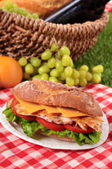 Chicken salad baguette sandwich with picnic basket 