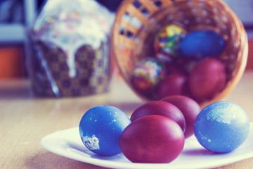 Painted colorful easter eggs and easter cake. Selective focus on eggs. Image with vintage filter