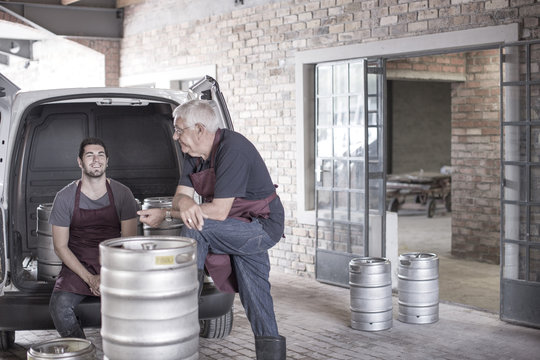 Brewers loading kegs into back of van