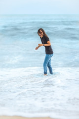 happy beautiful woman enjoying the waves on the tropical sea