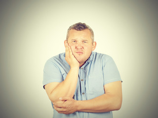 Fat man with a toothache.