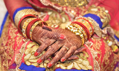 Fototapeta premium Bridal henna covered hands of an Indian Bride