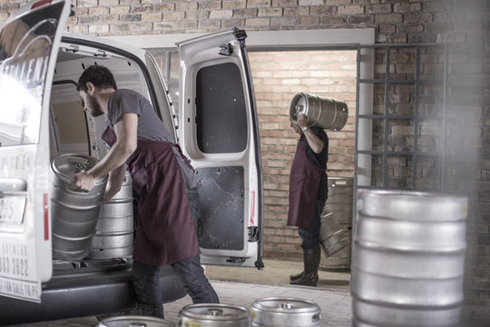 Brewers Loading Kegs Into Back Of Van