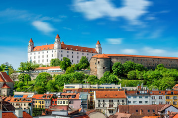 View on Bratislava castle on the green hill with old houses at the bottom from the Michael's watch tower in Slovakia - obrazy, fototapety, plakaty
