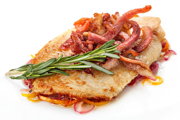 Piece of fillet  on a plate decorated with a sprig of rosemary,