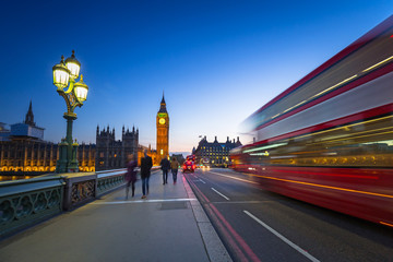 London scenery at Westminter bridge with Big Ben and blurred red bus, UK