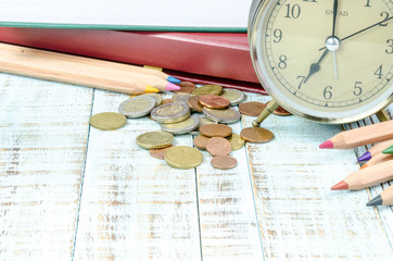 Vintage books and clock on wooden table with copy space