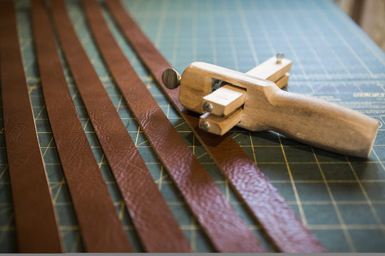 Row of leather strips on workshop bench