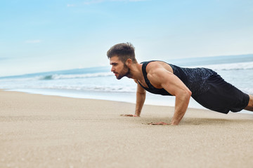 Fototapeta na wymiar Workout Exercise. Closeup Of Healthy Handsome Active Man With Fit Muscular Body Doing Push Ups Exercises. Sporty Athletic Male Exercising At Beach, Training Outdoor. Sports And Fitness Concept