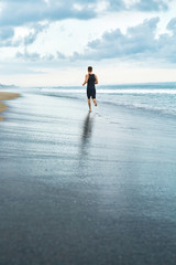 Fitness. Fit Athletic Man Running On Beach. Jogger Exercising And Training For Marathon. Sporty...