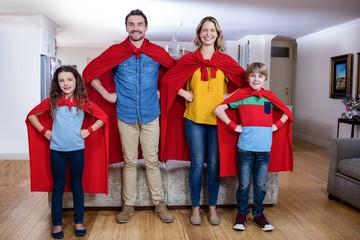 Portrait of a family pretending to be superhero in living room