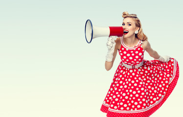 happy woman holding megaphone, dressed in pin-up style red dress